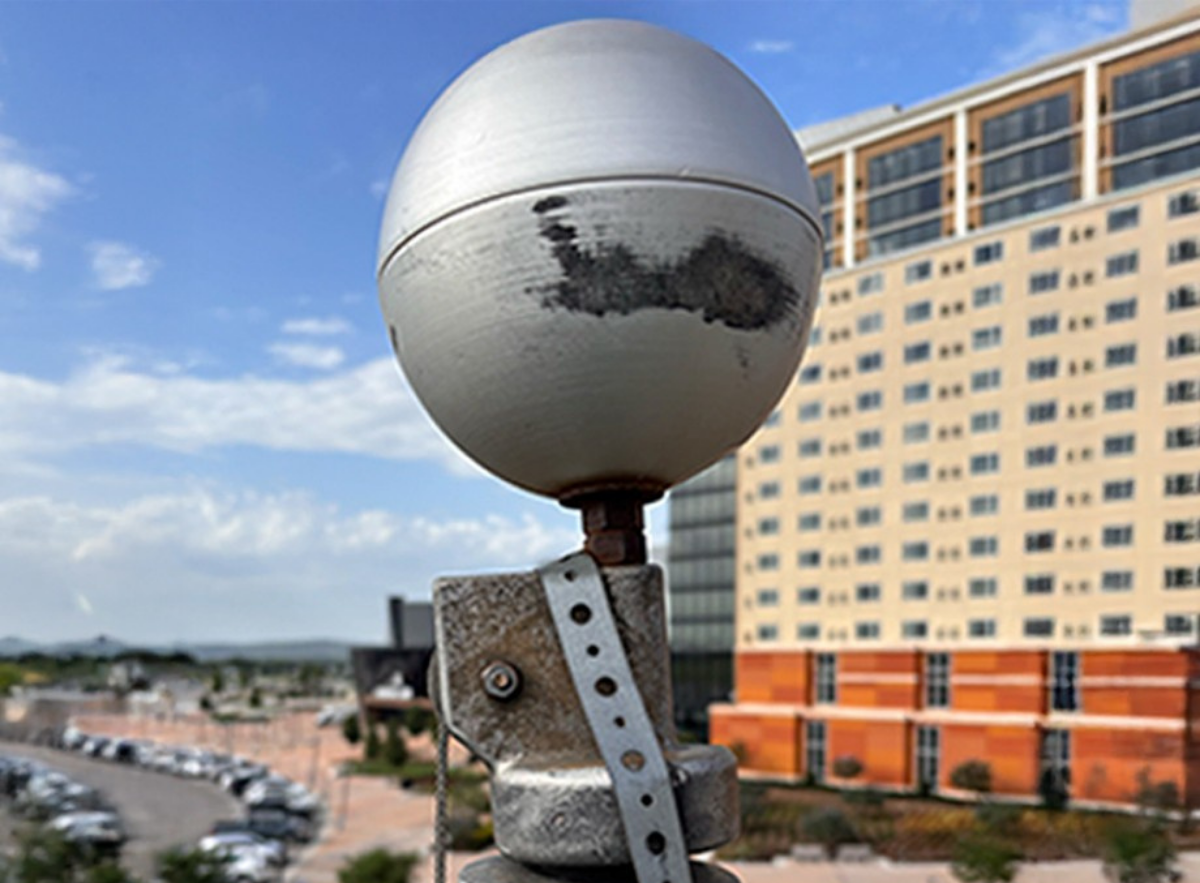 Close-up of a worn flagpole truck ball ornament needing repair